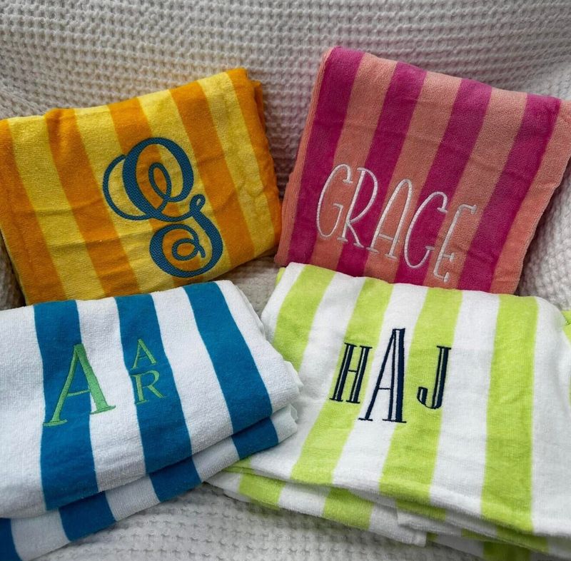 Four striped beach towels with monograms and the name Grace