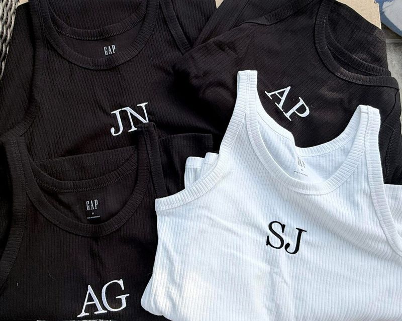 Black and white ribbed tanks with two-letter monograms