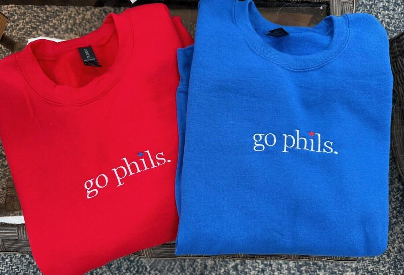 Red and royal blue crewnecks, each embroidered go phils. with a small star over the i