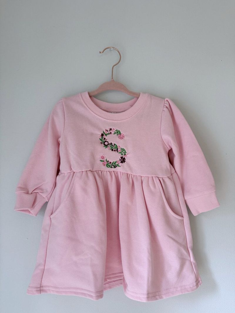 Pink dress with a floral letter S